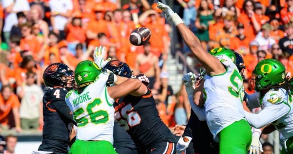 Jaedon Moore No. 56 and Derrick Harmon No. 55 who blocks a pass_Eric Becker.jpg